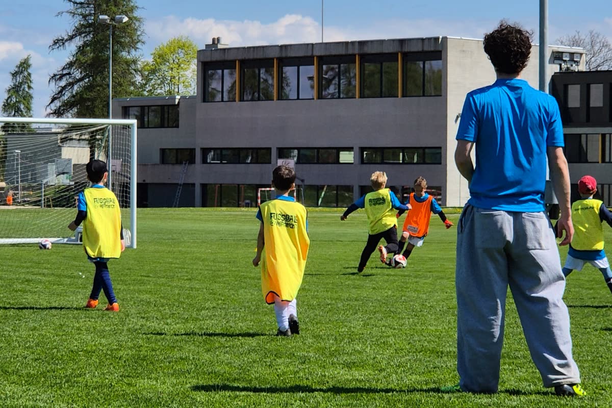 Spielform im Training: Kinder in Leibchen kämpfen um den Ball